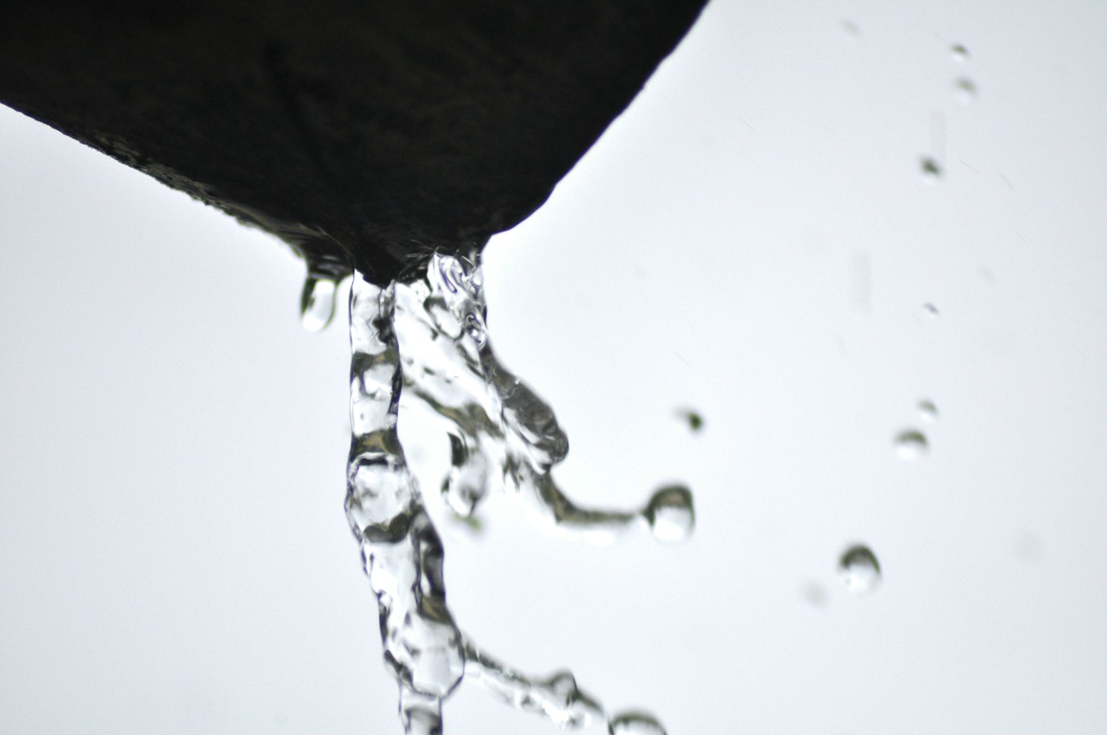 a close up of a water faucet with drops of water on it